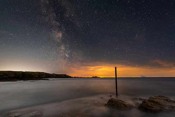 The Last Post on the outer Firth of Clyde. What a dream it was to photograph our galactic centre rising above the Out Firth of Clyde and Ailsa Craig!With the bright white lights of Girvan on the horiz