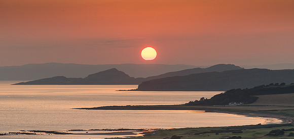 Sun setting over  Ardneil bay, Little Cumbrae and the Isle of Bute.